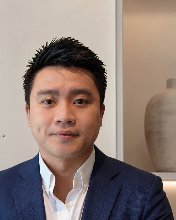 Darren Tan, seated at his desk